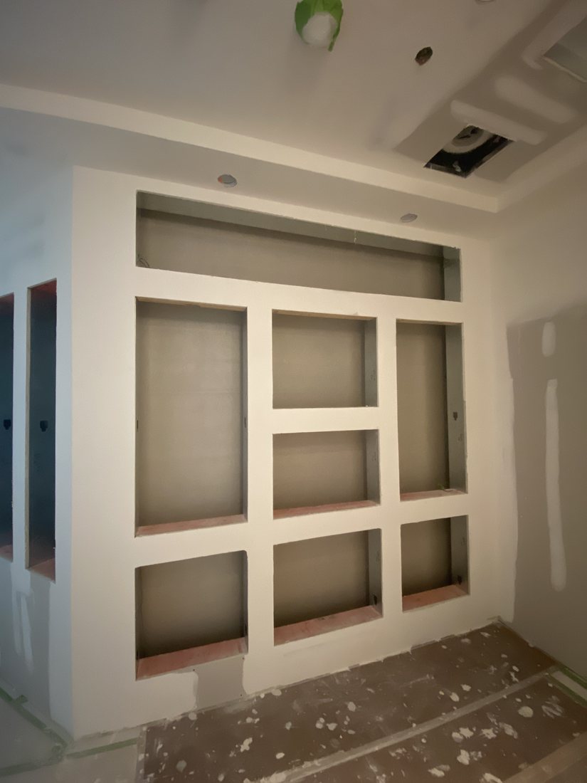 Drywall built-in with recessed panels, ready for paint