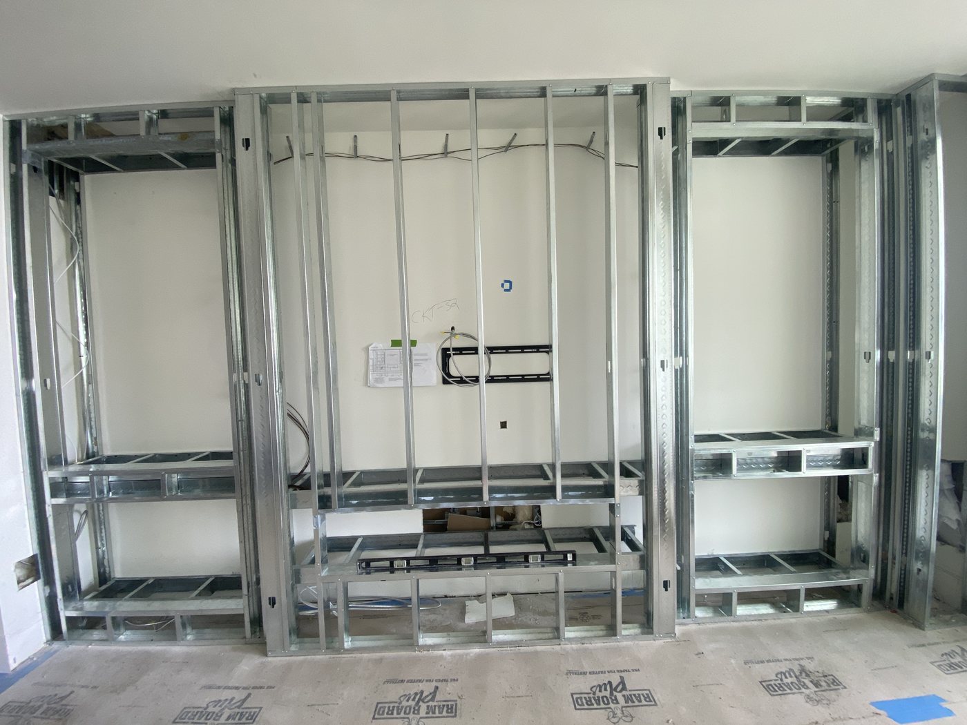 Metal stud framing for a media wall with niches and shelf blocking