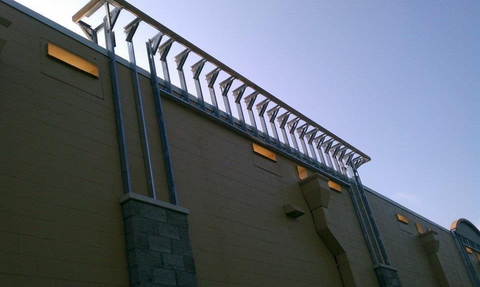 Steel entrance canopy along the building exterior at dusk